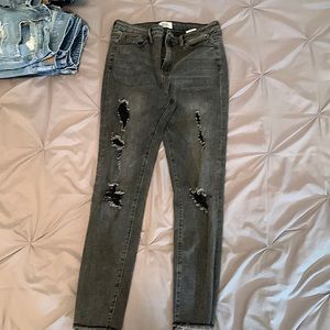 Selling a pair of grey ripped jeans